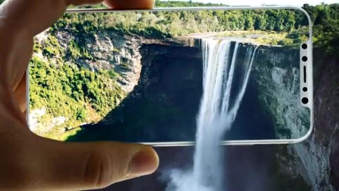 增强现实。美丽的风景锁在智能手机里。瀑布从屏幕上涌出