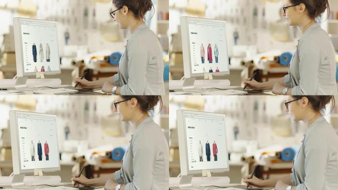 女性时装设计师在她的个人电脑上使用数字绘图板，她为在线零售店设计新网站。背景阳光明媚的工作室里有面料