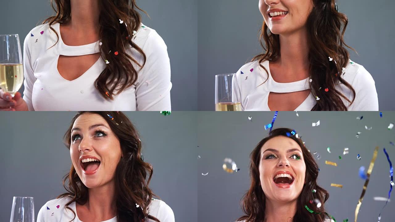 激动的女人拿着香槟杯看着五彩纸屑4k