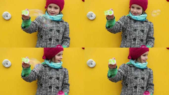 制造气泡外国小女孩吹泡泡戴着红帽子