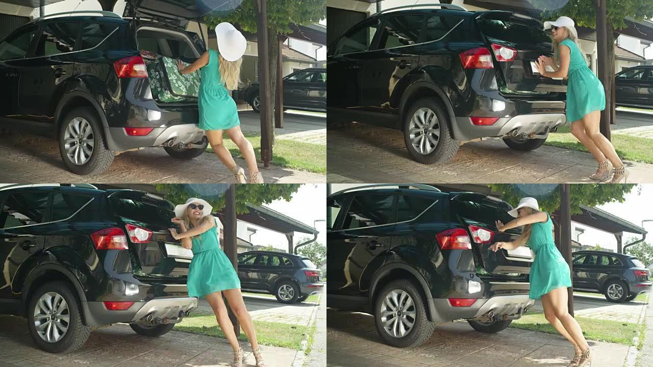 慢动作: 兴奋的年轻女子努力关闭黑色SUV的后备箱。