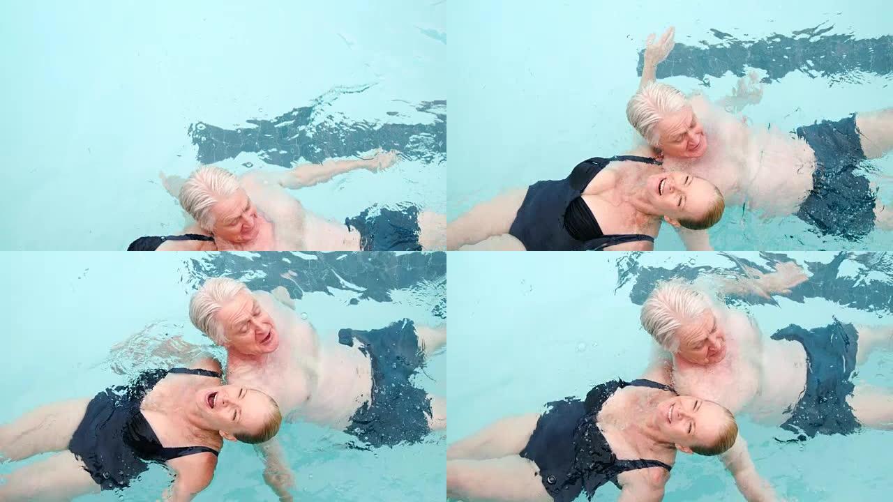 快乐的高级夫妇在游泳池游泳