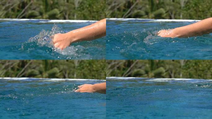 慢动作: 女性手在光滑的水面上轻轻滑动的细节