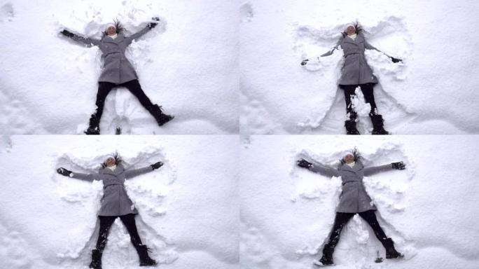 慢动作: 年轻女子制作雪天使