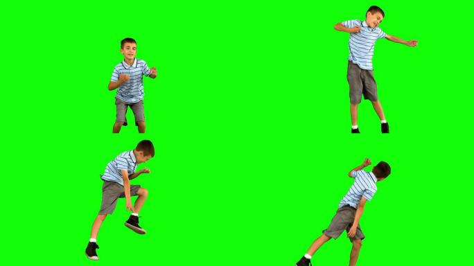 小男孩在绿色屏幕上跳跃