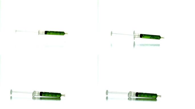 绿色液体掉落的注射器