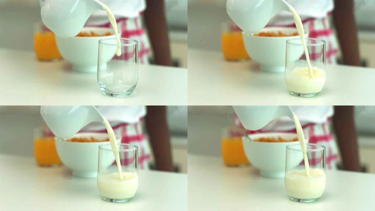 早餐时将牛奶倒入玻璃杯中