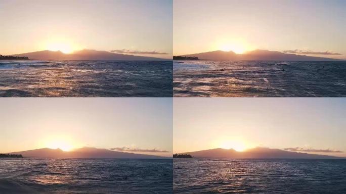 日落时飞越漂浮在海浪中的冲浪者。惊人的日落空中海景