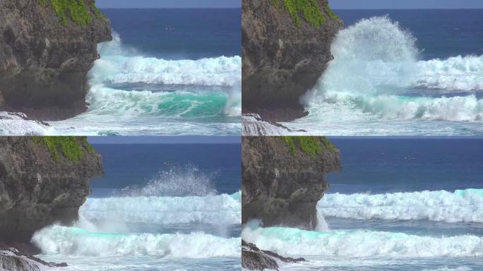 慢动作，空中: 惩罚翡翠色的海浪袭击了黑色悬崖。