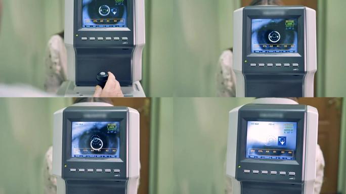 医生正在检查人的眼睛，他们的图像显示在屏幕上