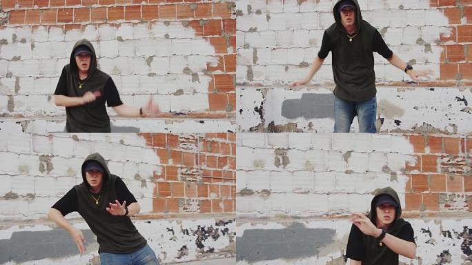 男子嘻哈在砖墙前的城市外面跳舞
