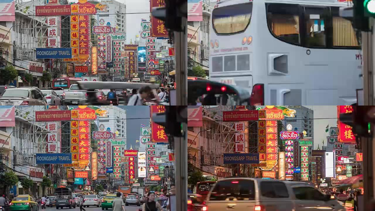 黄昏时，Yaowarat路上的交通在唐人街区的照明标志下通过