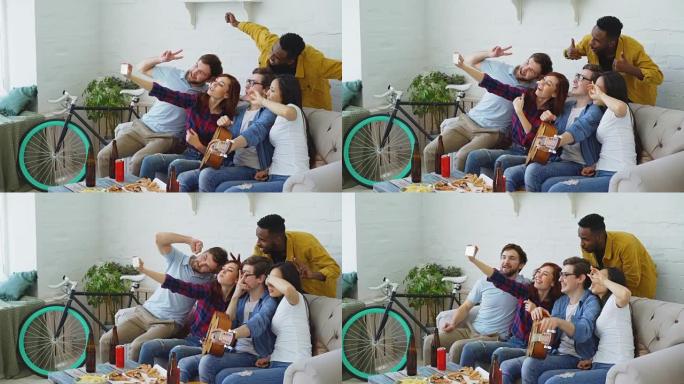 一群快乐的朋友在智能手机相机上拍照，同时在家室内用啤酒和小吃庆祝派对