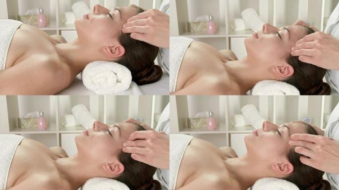 高清起重机: 年轻漂亮的女人接受面部按摩