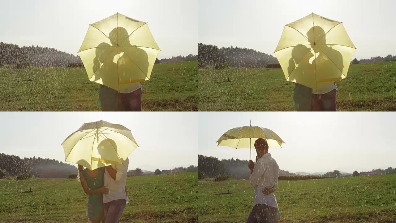 慢动作: 幸福的年轻夫妇在雨中亲吻并继续浪漫漫步