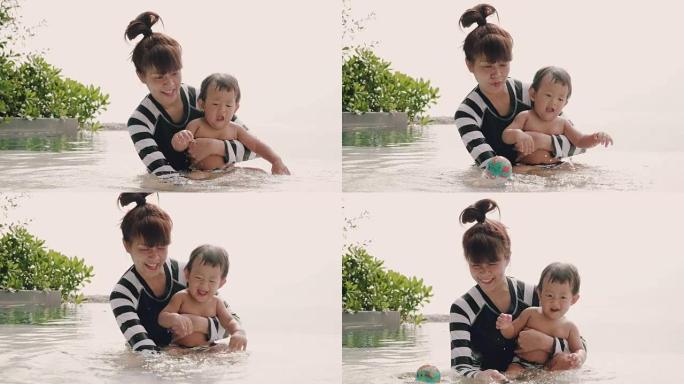 男婴和妈妈在游泳池
