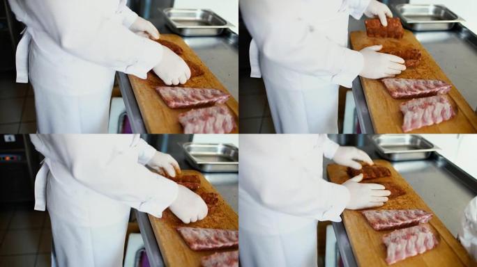 专业厨师的特写镜头在餐厅厨房的切菜板上准备带有香料的排骨