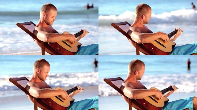 男人在沙滩上弹吉他
