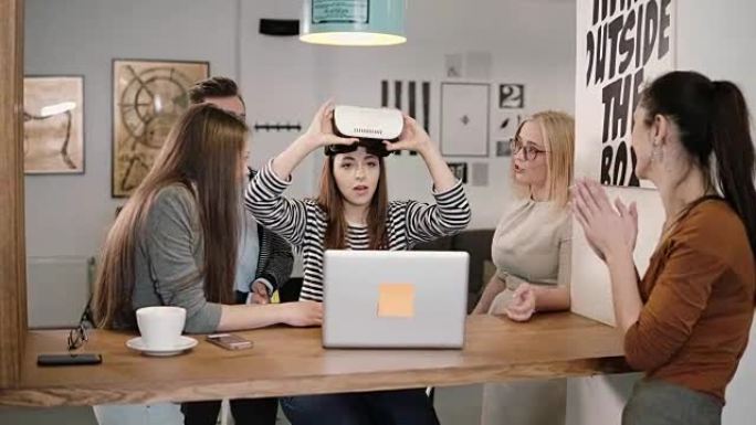 女孩在使用新应用程序后摘下眼镜虚拟现实与创业办公室的团队分享经验