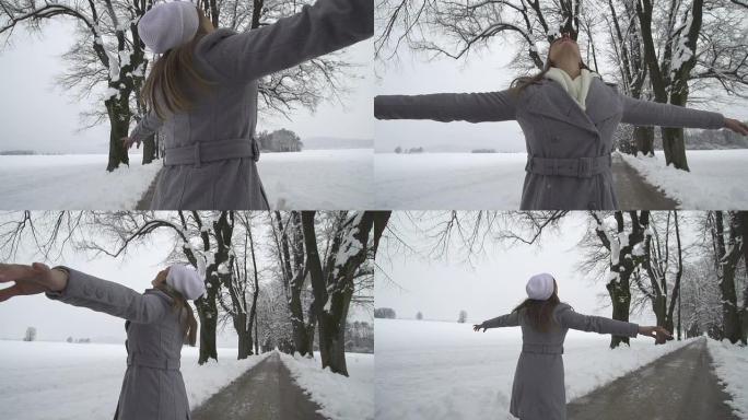 慢动作: 年轻女子在冬树大道上旋转