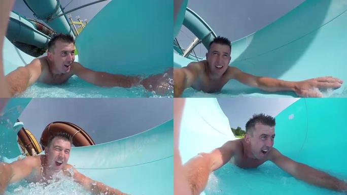 自拍照: 在阳光明媚的夏天，激动的年轻成年男子在fun aqua park滑下水滑梯