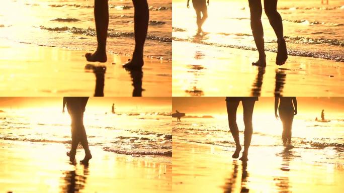 慢动作特写: 人们在惊人的金色日落中沿着海滩散步