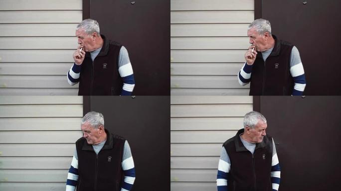 一位头发花白的老人抽烟低头看。慢mo