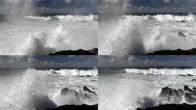 巨浪冲破危险岩石的可怕力量。慢动作镜头