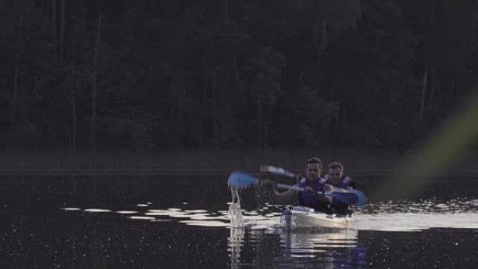 Summer relaxing activity. Young man kayaking on th