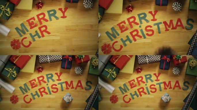 用彩色纸质字母制成的 “圣诞快乐” 的手的俯视图延时。