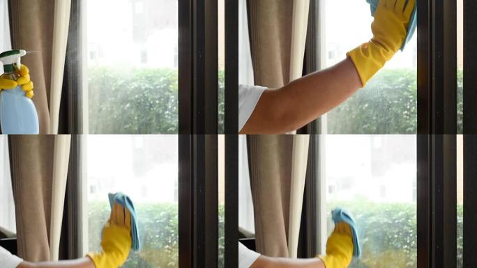 清洁喷涂在窗户玻璃上并用超细纤维布擦拭，清洁镜头概念