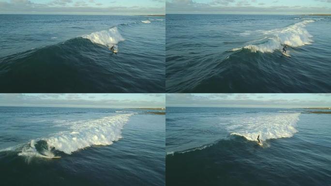 空中慢动作: 渴望冲浪的人在日出时骑着桶波倒下