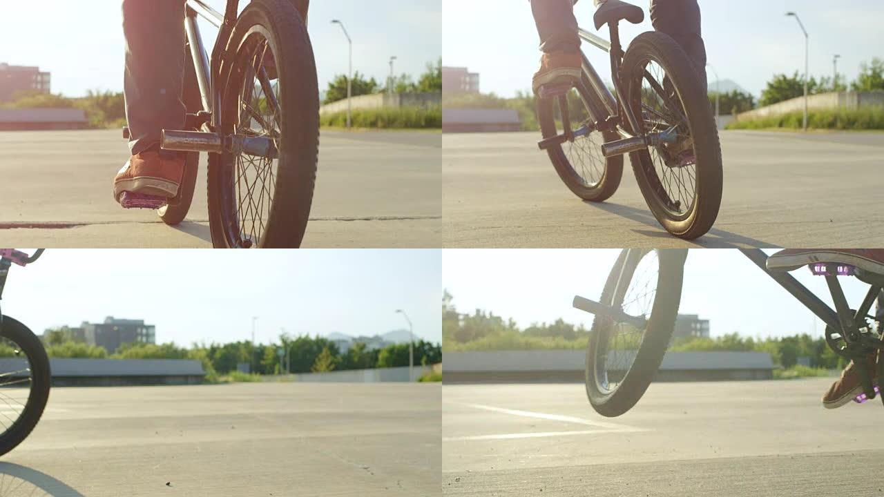 慢动作特写: Bmx骑自行车的人在日落的阳光下做很酷的跳跃技巧