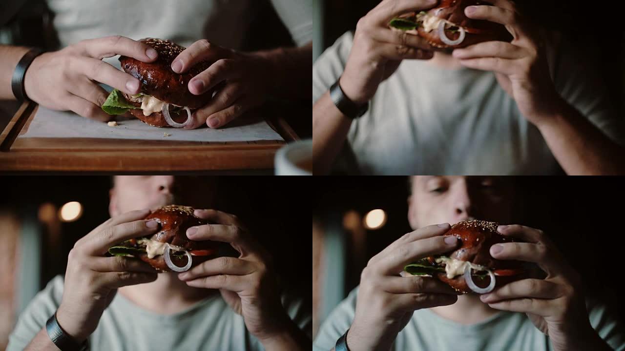 美味的汉堡在木托盘上很棒。一个男人拉着他的手吃东西，尝尝味道