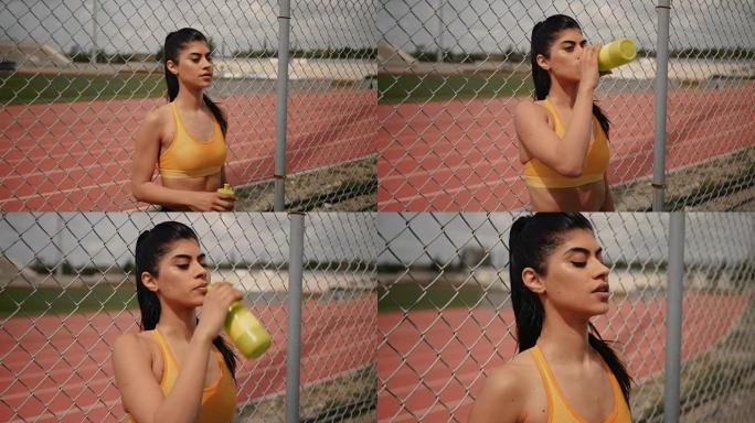 疲惫的运动女性喝水，锻炼后放松