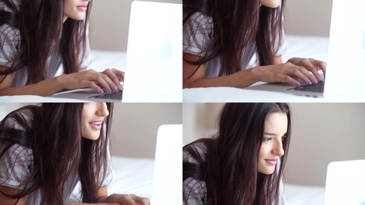 床上的女人正在用她的笔记本电脑浏览网页