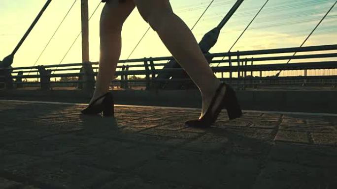 女商人穿着高跟鞋走在阳光下