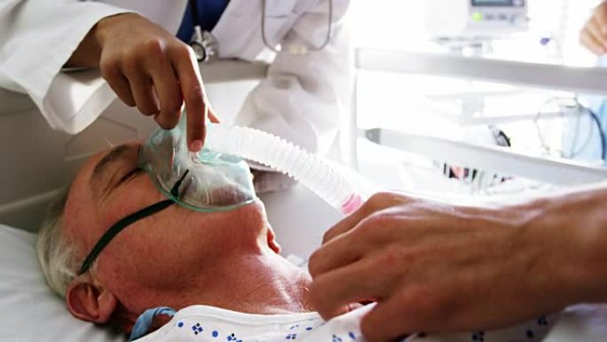 医生给一名女性高龄患者脸上戴上氧气面罩