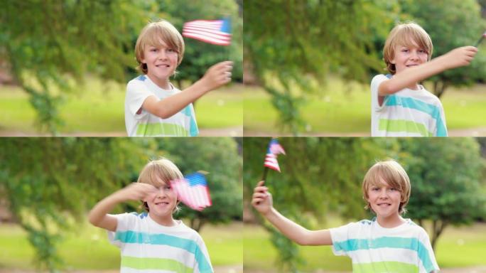小男孩对着镜头微笑，挥舞着美国国旗