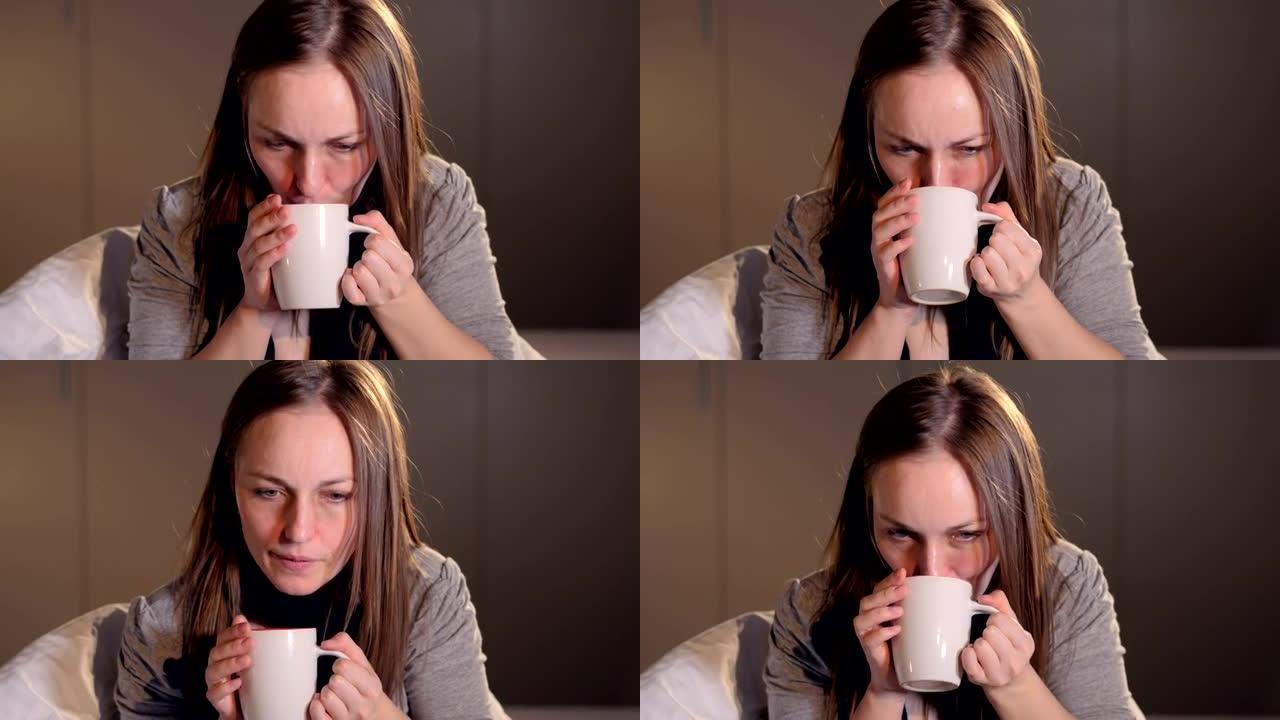 年轻女子喝热茶的肖像。特写。4K。