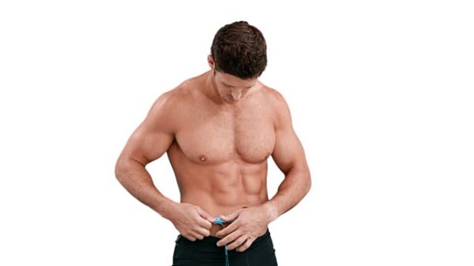 肌肉发达的男人测量他的腰