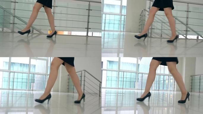 穿着高跟鞋走在办公室走廊的女商人