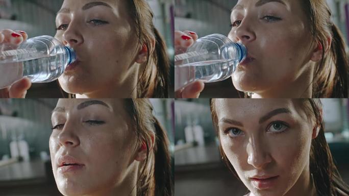 出汗的女运动员饮用水
