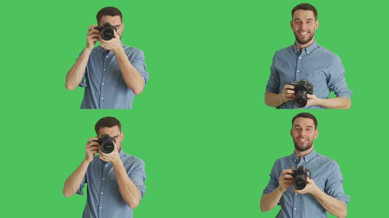 一个英俊的摄影师拍照的中间镜头。背景是绿色屏幕。