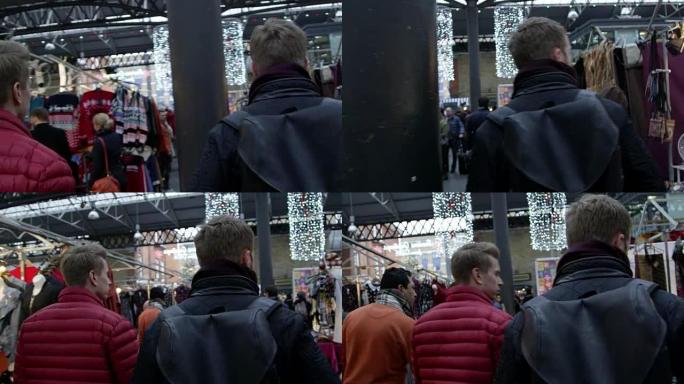两名年轻人在R3D上穿越圣诞节市场拍摄