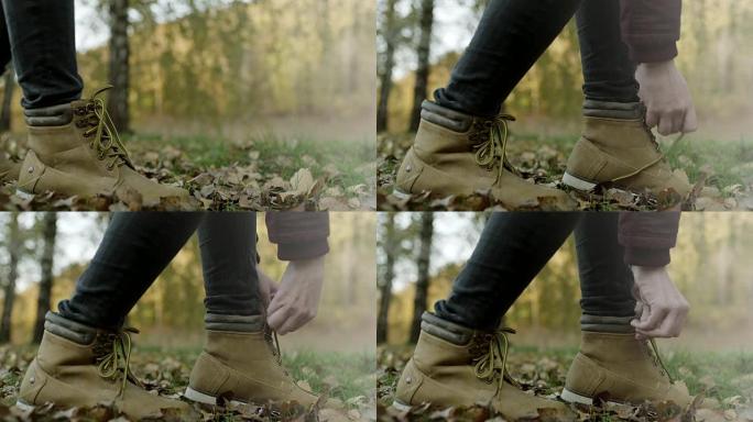特写，女人在秋叶上系鞋带
