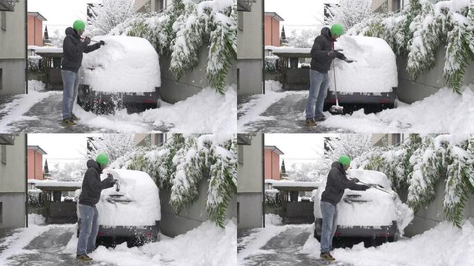 男子清理汽车上的积雪