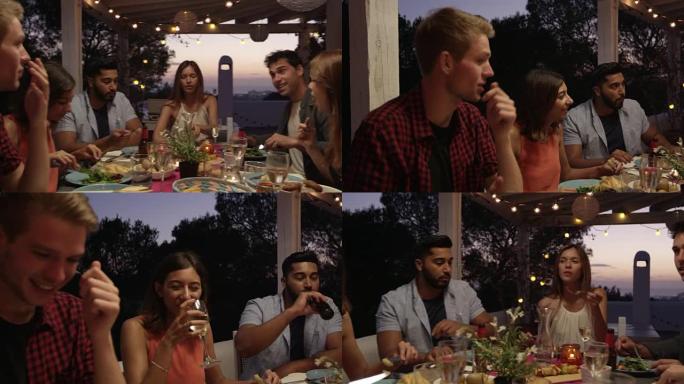 在R3D拍摄的伊比沙岛屋顶露台上的晚宴上聊天的朋友