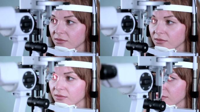 用现代医疗设备检查眼睛的年轻女子