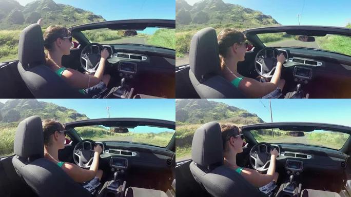 慢动作: 快乐的年轻女子在夏威夷阳光明媚的假期驾驶敞蓬车